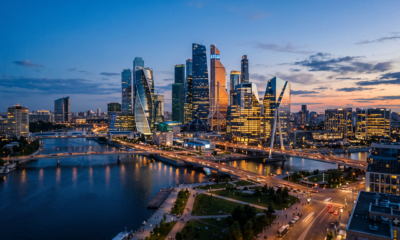 Photorealistic dusk skyline of modern glass office towers representing a tech innovation hub.