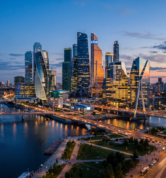 Photorealistic dusk skyline of modern glass office towers representing a tech innovation hub.